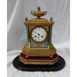 A 19th century French ormolu and porcelain clock, with a vase and pineapple finials,