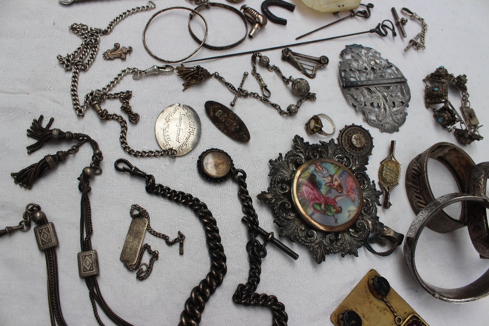 A quantity of silver and white metal jewellery, including hinged bangles, nurses belts,