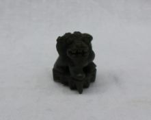 A green jade model of a Dog of Foo, in dark green,