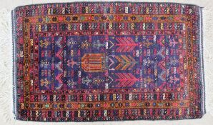 A rug, with blue ground, central temple, trees etc, with multiple guard stripes,