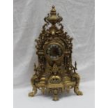 A modern gilt brass bracket clock with an urn finial, profusely decorated with leaves, flowers,