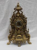 A modern gilt brass bracket clock with an urn finial, profusely decorated with leaves, flowers,