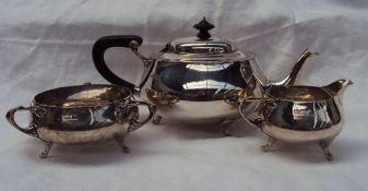 A George V silver three piece tea set, comprising a teapot, cream jug and three handled sugar basin,