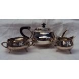 A George V silver three piece tea set, comprising a teapot, cream jug and three handled sugar basin,