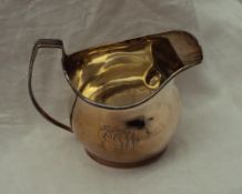 A George V Britannia silver cream jug with a line decorated rim, London, 1913,