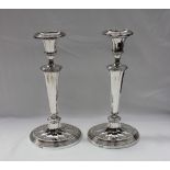 A pair of late Victorian silver candlesticks, of oval form,