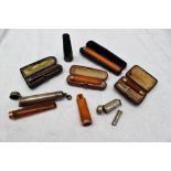 A silver cigar holder, together with 9ct gold and amber mouthpieces,
