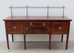 A 19th century mahogany sideboard, with a brass gallery above a rectangular cross banded top,