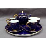 A Royal Worcester tea for two set, comprising a tray, teapot with bamboo handle, two cups,