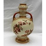 A Royal Worcester porcelain twin handled vase decorated with flowers and leaves to an ivory ground,