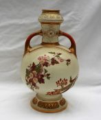 A Royal Worcester porcelain twin handled vase decorated with flowers and leaves to an ivory ground,