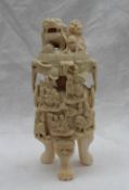 An early 20th century Chinese carved ivory twin handled vase and cover decorated with a dog of foo