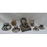 A continental white metal inkwell with a horse shoe shaped pen rest,