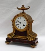 A 19th century ormolu and variegated red marble mantle clock,
