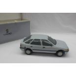 A Lladro model of a Ford Escort, 1990, blue printed mark,