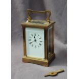 A French brass carriage timepiece, the rectangular dial with Roman numerals,