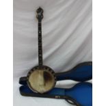 An Abbott of London four string banjo, with mother of pearl inlay,