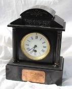A George V black slate mantle clock of architectural form with a domed top with a blind frieze,