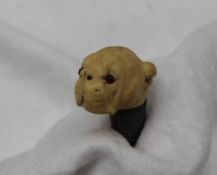 A late Victorian carved ivory walking stick head, in the form of a boxer type dog, with glass eyes,