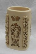 An early 20th Japanese carved ivory brush pot, with pierced and carved decoration of chrysanthemums,