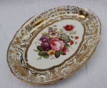 A 19th century English pottery oval dish, with a gilt rim,