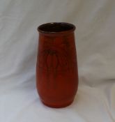 A T W Lemon's Wesuma ware pottery vase, with an orange ground incised with flowers and leaves,