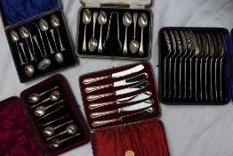 An Edwardian silver dessert set comprising six spoons and matching forks, London, 1909,