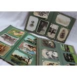 Three postcard albums containing circa 300 cards, including photographic cards,