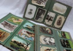 Three postcard albums containing circa 300 cards, including photographic cards,