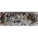 A large collection of costume jewellery including bead necklaces, brooches, rings, albert chains,