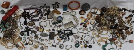 A large collection of costume jewellery including bead necklaces, brooches, rings, albert chains,