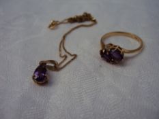 An Amethyst and Diamond ring set with a pair of oval amethysts flanked by two round brilliant cut