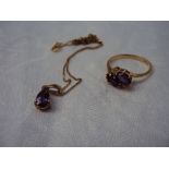 An Amethyst and Diamond ring set with a pair of oval amethysts flanked by two round brilliant cut