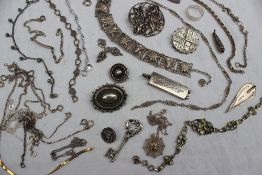 A silver ingot together with a collection of silver and white metal jewellery including brooches,