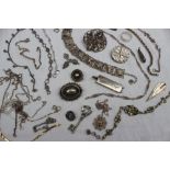 A silver ingot together with a collection of silver and white metal jewellery including brooches,