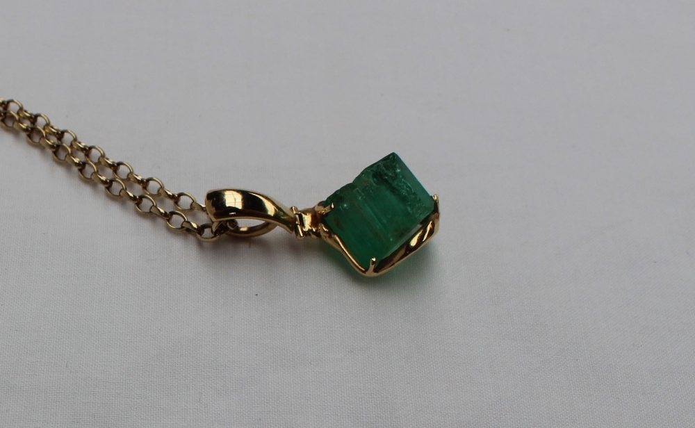 A Columbian Emerald uncut of irregular shape to a yellow metal hinged setting on a 9ct yellow gold - Image 2 of 5