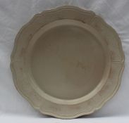 An 18th century salt glazed plate of shaped edge with a moulded rim,