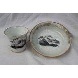 A Swansea porcelain tea cup and saucer, with monochrome decoration of a landscape scene,