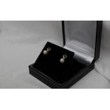 A pair of pearl and diamond earrings,