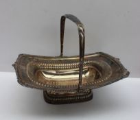 A 19th century silver swing handled cake basket, of rectangular form with a shell and gadrooned rim,