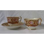 A Swansea porcelain trio, each with gilt decoration and panels of roses to a yellow ground,