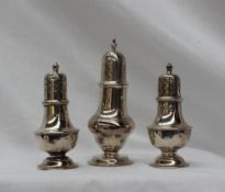 A late Victorian silver caster, with a pierced domed top and baluster body on a spreading foot,