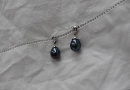 A pair of black pearl and diamond drop earrings,