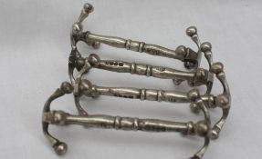 A set of four Victorian silver knife rests, with X frame and ball ends, London, 1863,