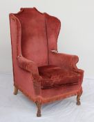 A George III style wing back armchair,