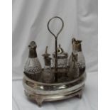 A George III silver cruet stand, of pointed oval form, with decorative roundels, on four feet,