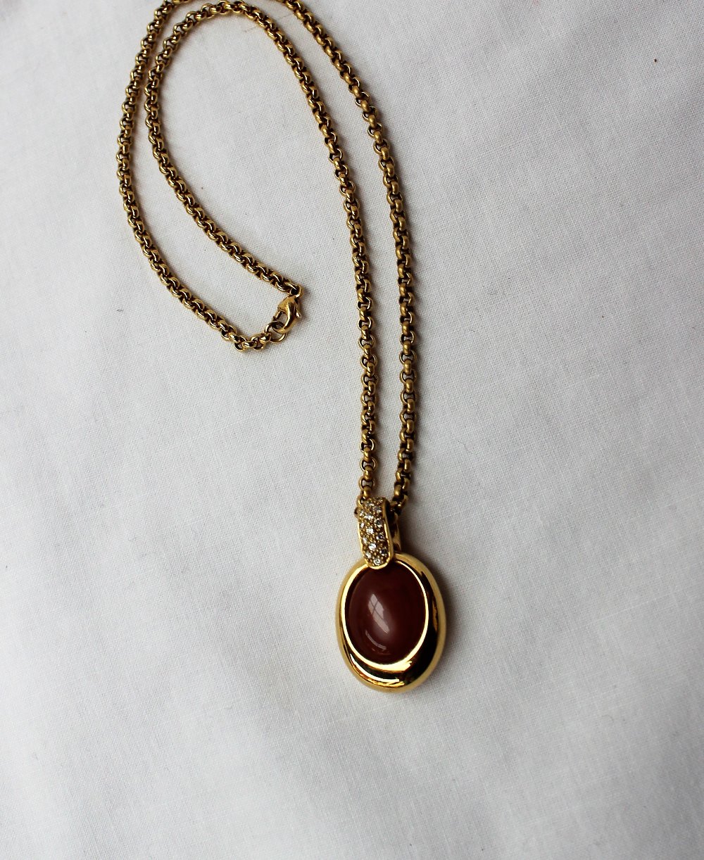 An 18ct yellow gold diamond and hardstone pendant on an 18ct yellow gold chain,