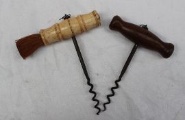 A bone corkscrew, with a turned handle and brush, together with a turned wooden handled corkscrew,