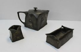 A Tudric pewter Art Nouveau style three-piece tea service, of square form with raised decoration,