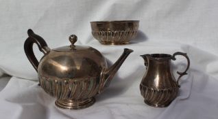 A Victorian three piece silver tea set, of spherical form with a partial gadrooned body, London,